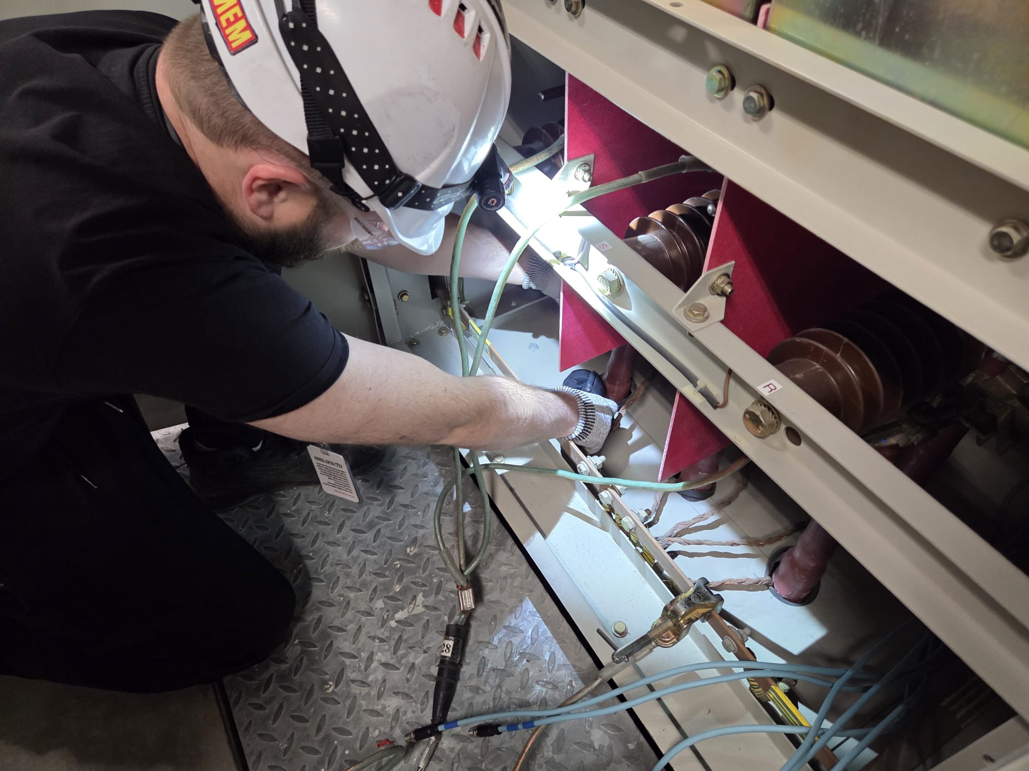 CONINT engineer installing CASSINI sensors inside a switchgear cabinet.